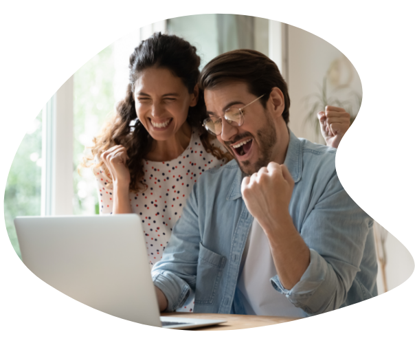 A couple celebrating at their laptop